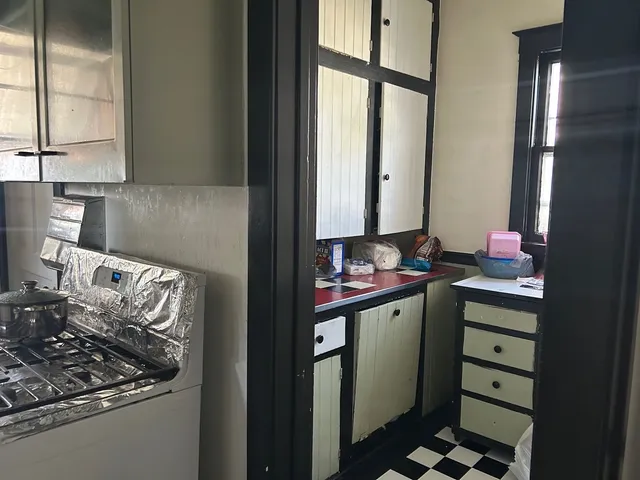 a kitchen with stainless steel appliances granite countertop a sink stove and cabinets