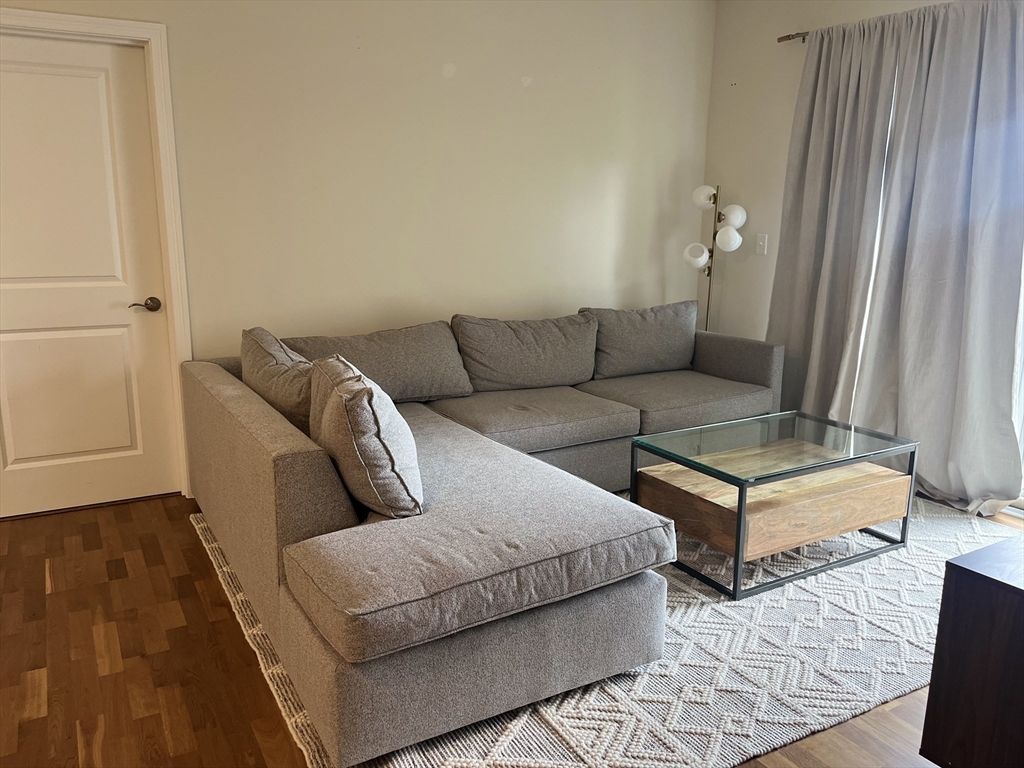 110 Trotter Road, Unit 308 Weymouth, MA 02190 - Photo 5 of 11 a living room with furniture and wooden floor
