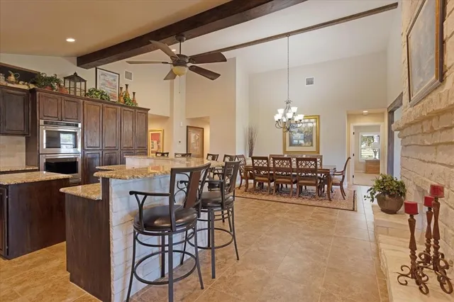 a view of a dining room with furniture and a chandelier