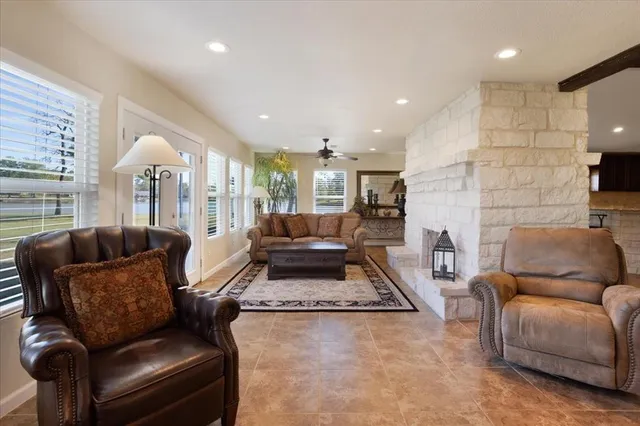 a living room with furniture fireplace and a view of kitchen