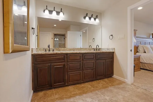 a spacious bathroom with a sink double vanity and a mirror