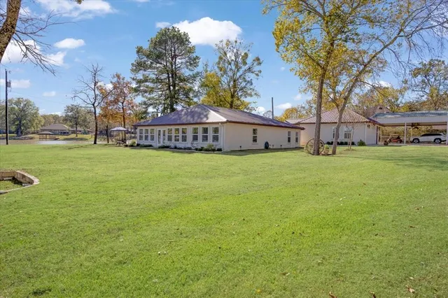 a view of a yard with a house in the background