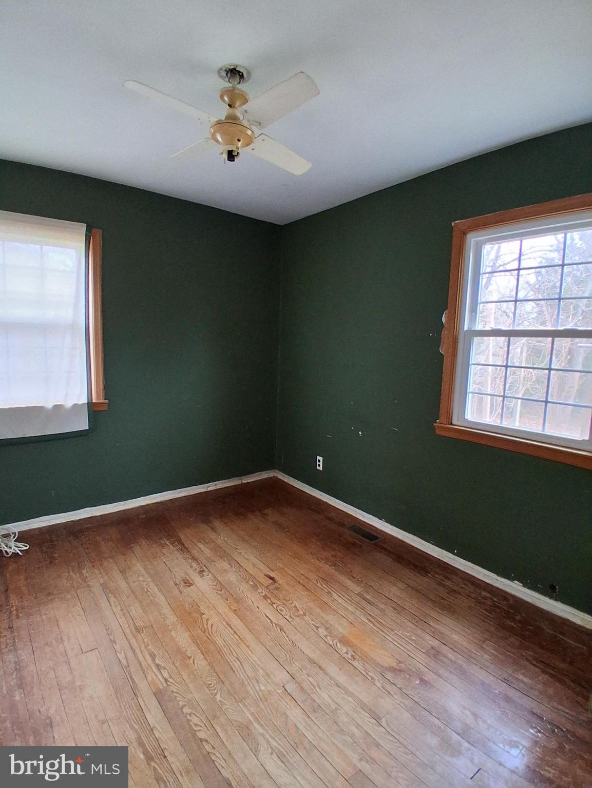 643 North Main Street Clayton, NJ 08312 - Photo 5 of 8 an empty room with wooden floor and windows