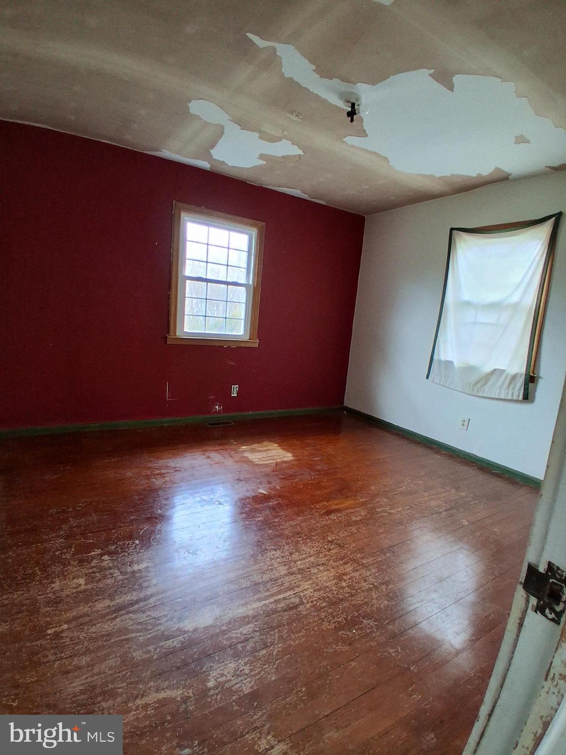 643 North Main Street Clayton, NJ 08312 - Photo 7 of 8 a view of an empty room with wooden floor and a window