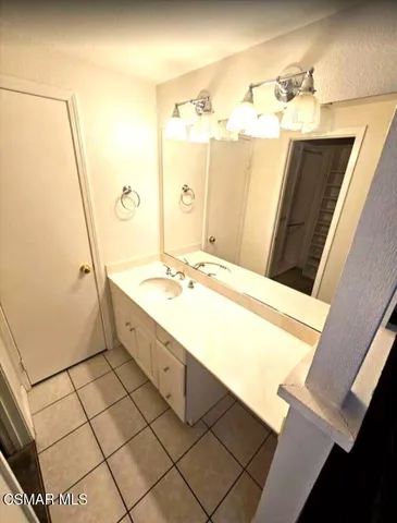 a bathroom with a sink vanity granite tub and shower