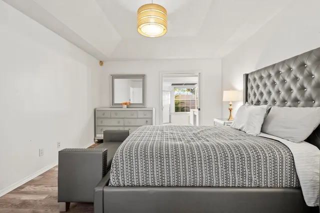 a bedroom with a bed and painting on the wall