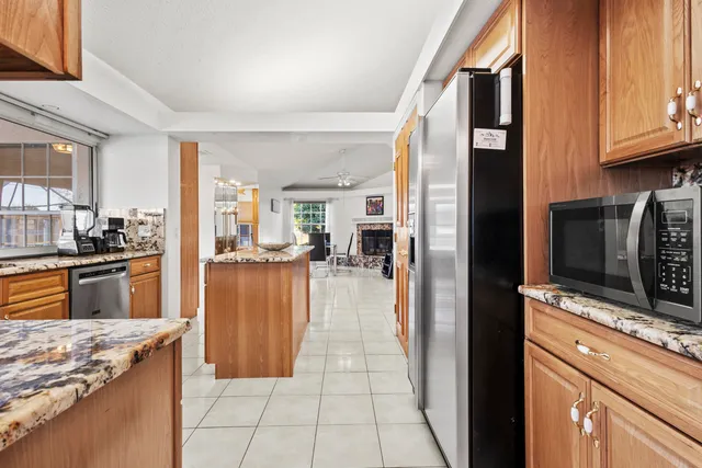 a kitchen with stainless steel appliances granite countertop a stove a sink and a refrigerator