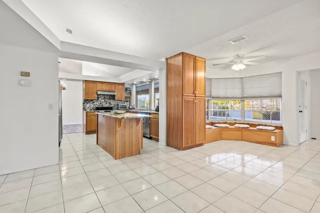 a open kitchen with stainless steel appliances granite countertop a refrigerator and a sink