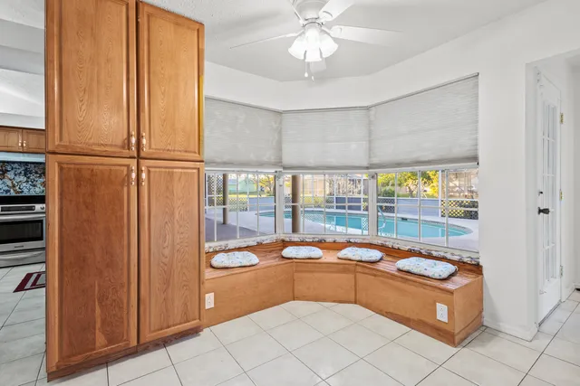 a bedroom with a bed flat screen tv and a window