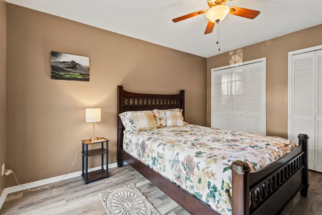 a bedroom with a bed and a flat tv screen on dresser