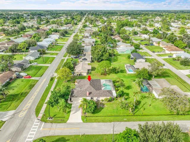 an aerial view of a house with a yard