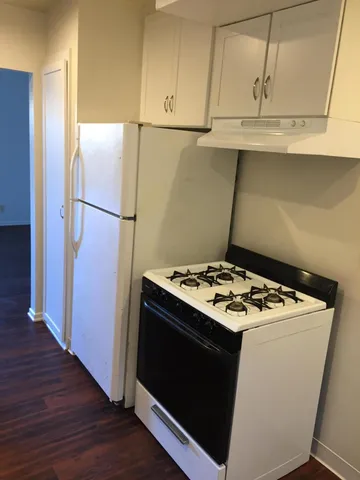 a kitchen with stainless steel appliances white cabinets and a sink