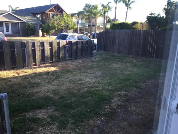 a swimming pool with outdoor seating and yard