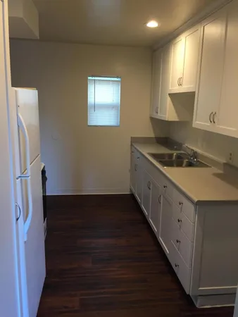 a stove top oven sitting inside of a kitchen