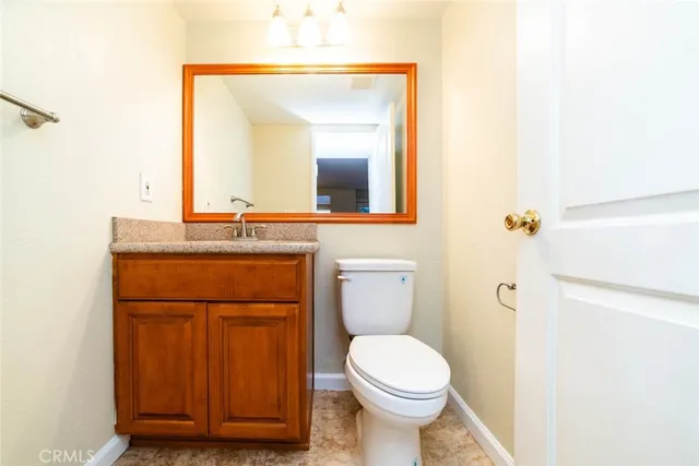 a bathroom with a sink a toilet and mirror