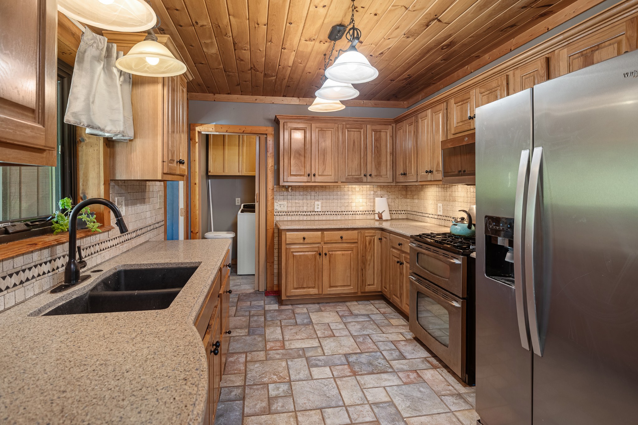 642 Beach Bottom Road Watertown, TN 37184 - Photo 9 of 48 a kitchen with granite countertop a sink stainless steel appliances and cabinets