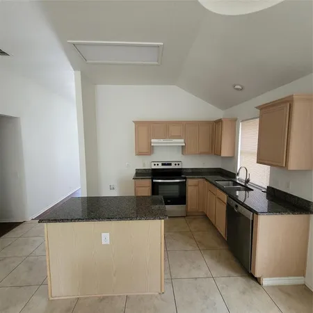 a kitchen with stainless steel appliances a sink stove and cabinets