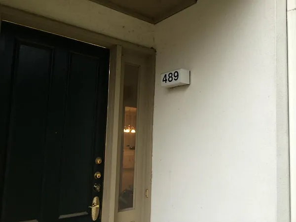 a kitchen with a white stove refrigerator and cabinets