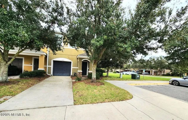 a view of a lake with a house and palm trees