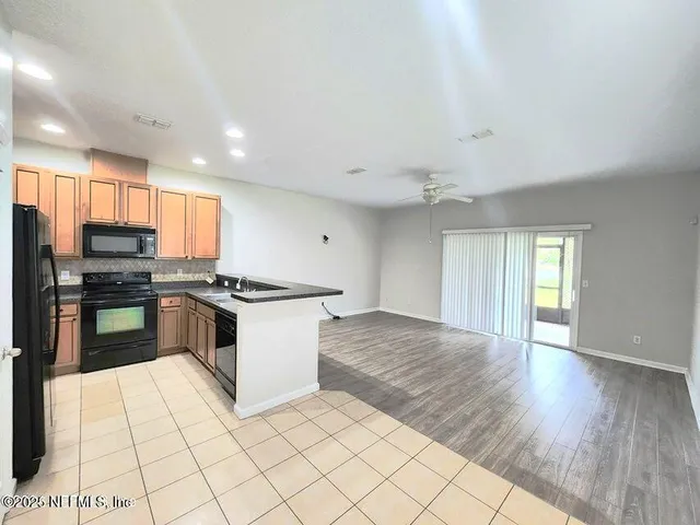a kitchen with stainless steel appliances a refrigerator and a stove top oven
