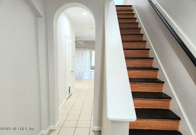 a view of entryway and hall with wooden floor