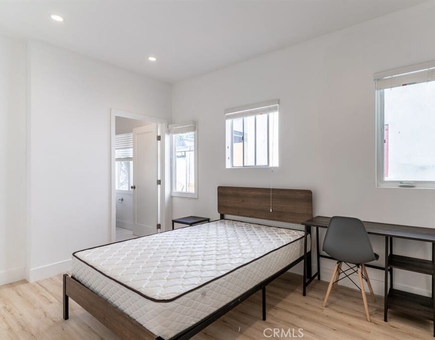 1213 West 24th Street Los Angeles, CA 90007 - Photo 4 of 11 a bedroom with a bed and a table in it