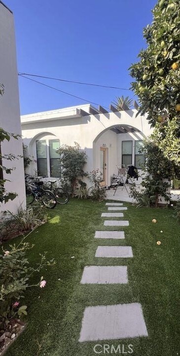 1213 West 24th Street Los Angeles, CA 90007 - Photo 9 of 11 a front view of a house with a yard