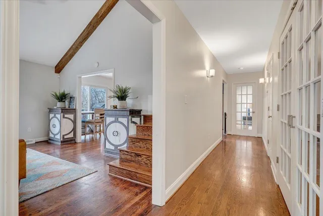 a open dining room with stainless steel appliances kitchen island granite countertop a table chairs and a view of living room