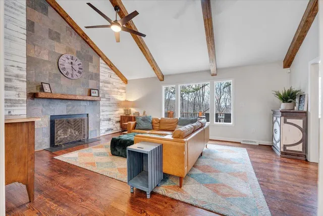 a view of a hallway with wooden floor and cabinet
