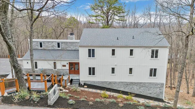 a front view of a house with basket ball court and glass windows