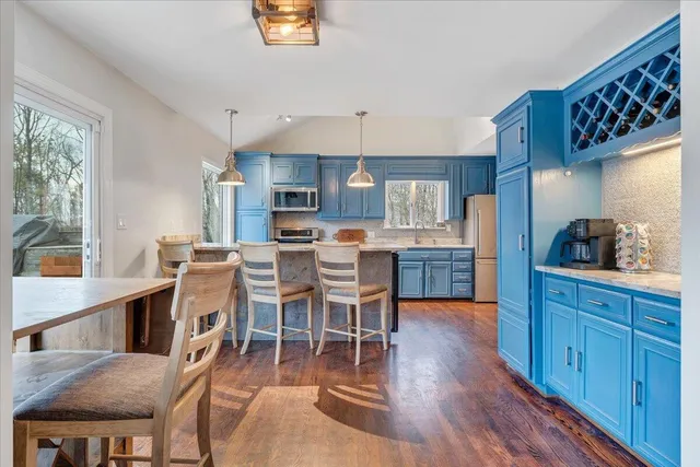 a view of living room kitchen with furniture and large window