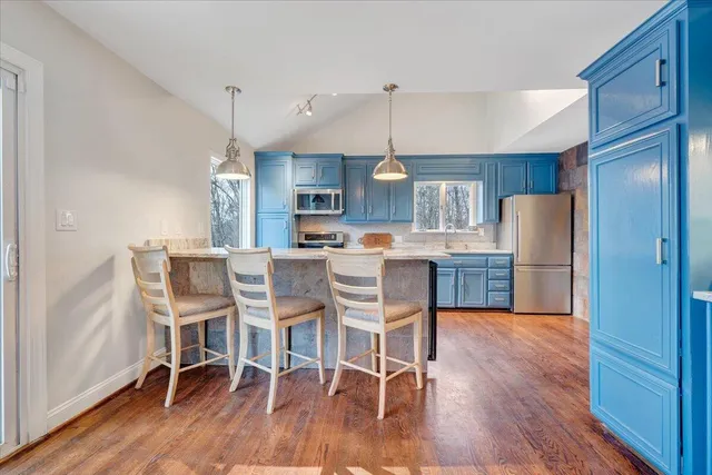 a view of an empty room with cabinet wooden floor and cabinet