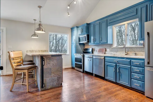 a backyard of a house with table and chairs