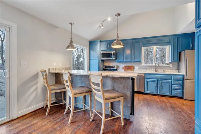 a view of a house with wooden deck front of house