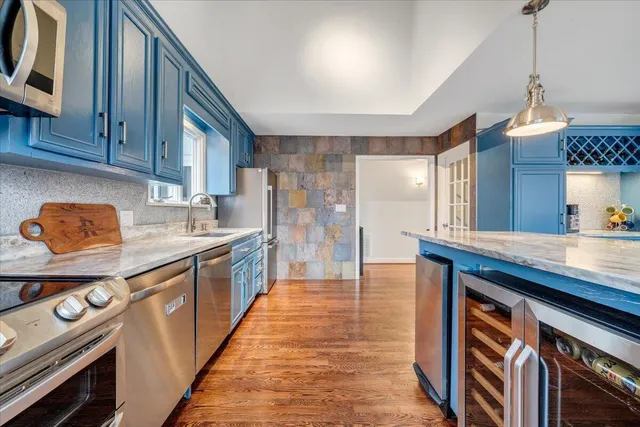a view of a house with a yard and potted plants