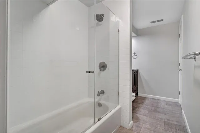 a view of a dry yard with trees and bushes