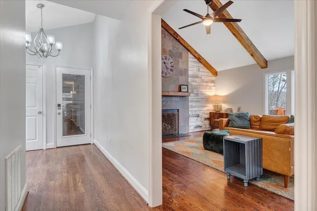 a living room with furniture a rug and a window