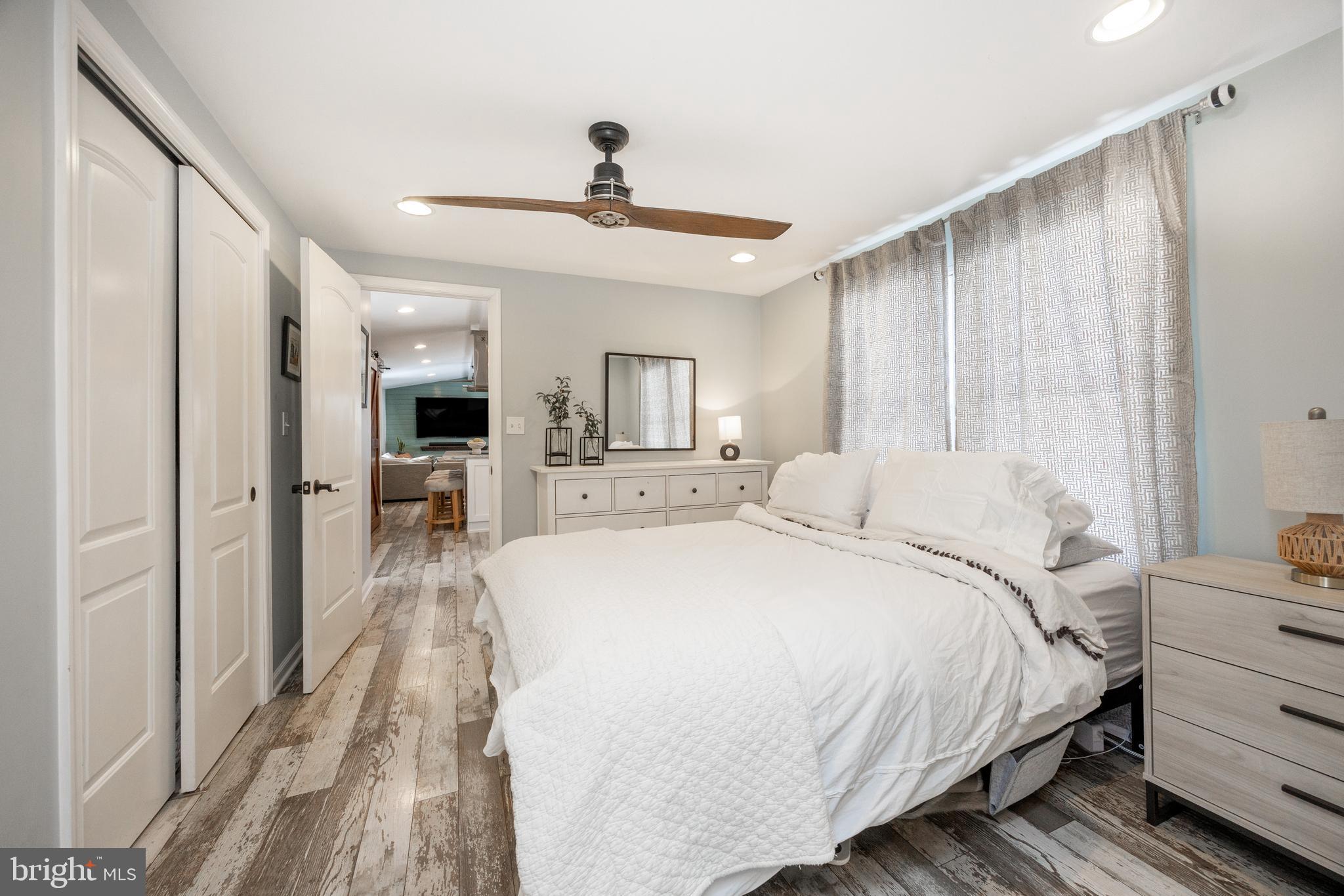 1524 Jonathan Road West Chester, PA 19380 - Photo 14 of 26 a spacious bedroom with a bed and a chandelier