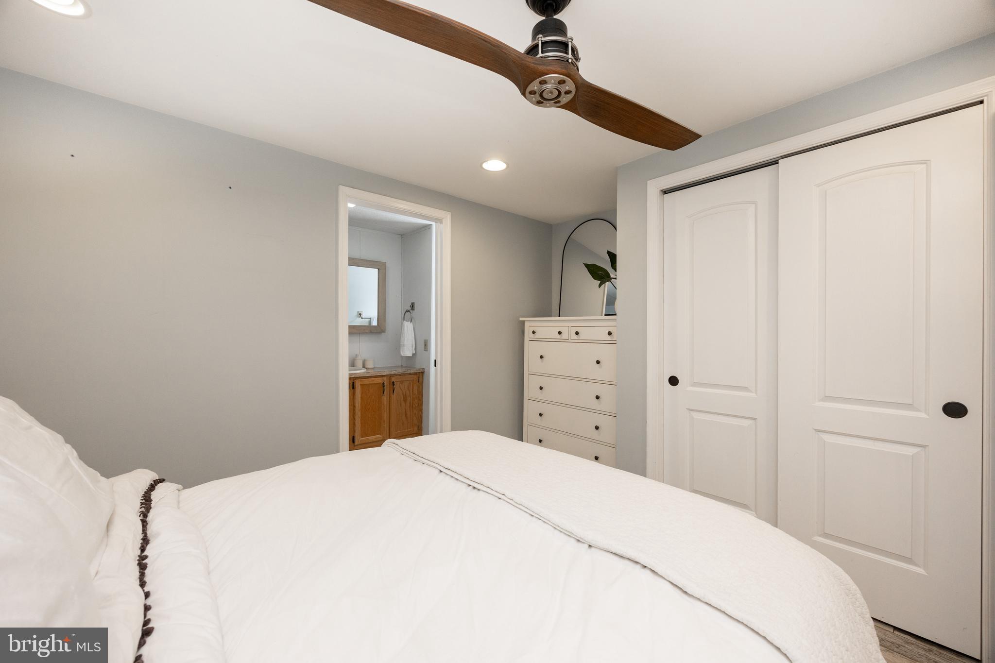 1524 Jonathan Road West Chester, PA 19380 - Photo 15 of 26 a bedroom with a large bed and a chandelier