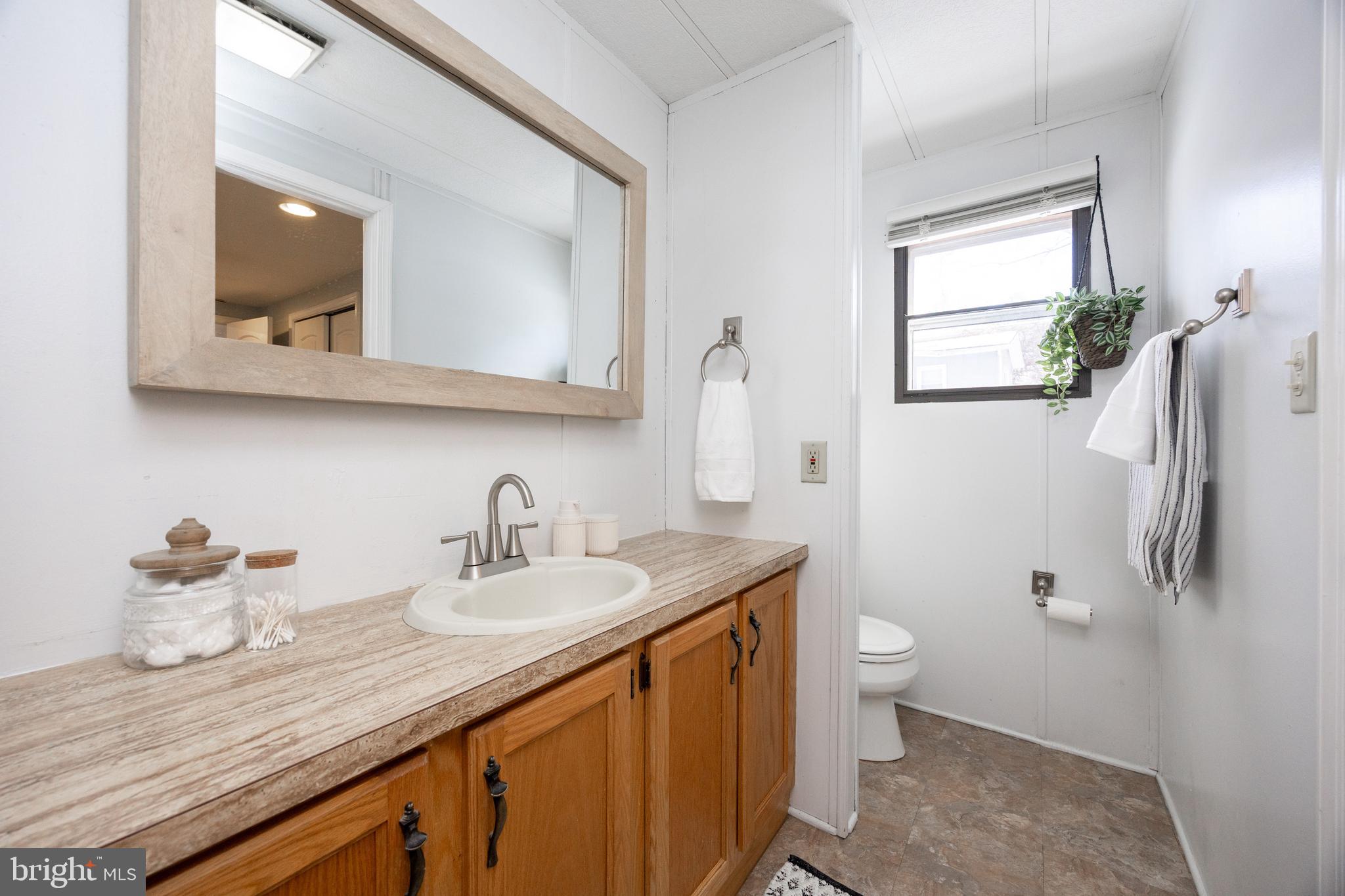 1524 Jonathan Road West Chester, PA 19380 - Photo 17 of 26 a bathroom with a granite countertop sink toilet and mirror