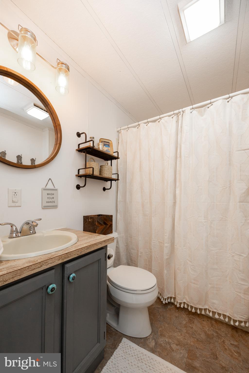 1524 Jonathan Road West Chester, PA 19380 - Photo 20 of 26 a bathroom with a toilet a sink and mirror