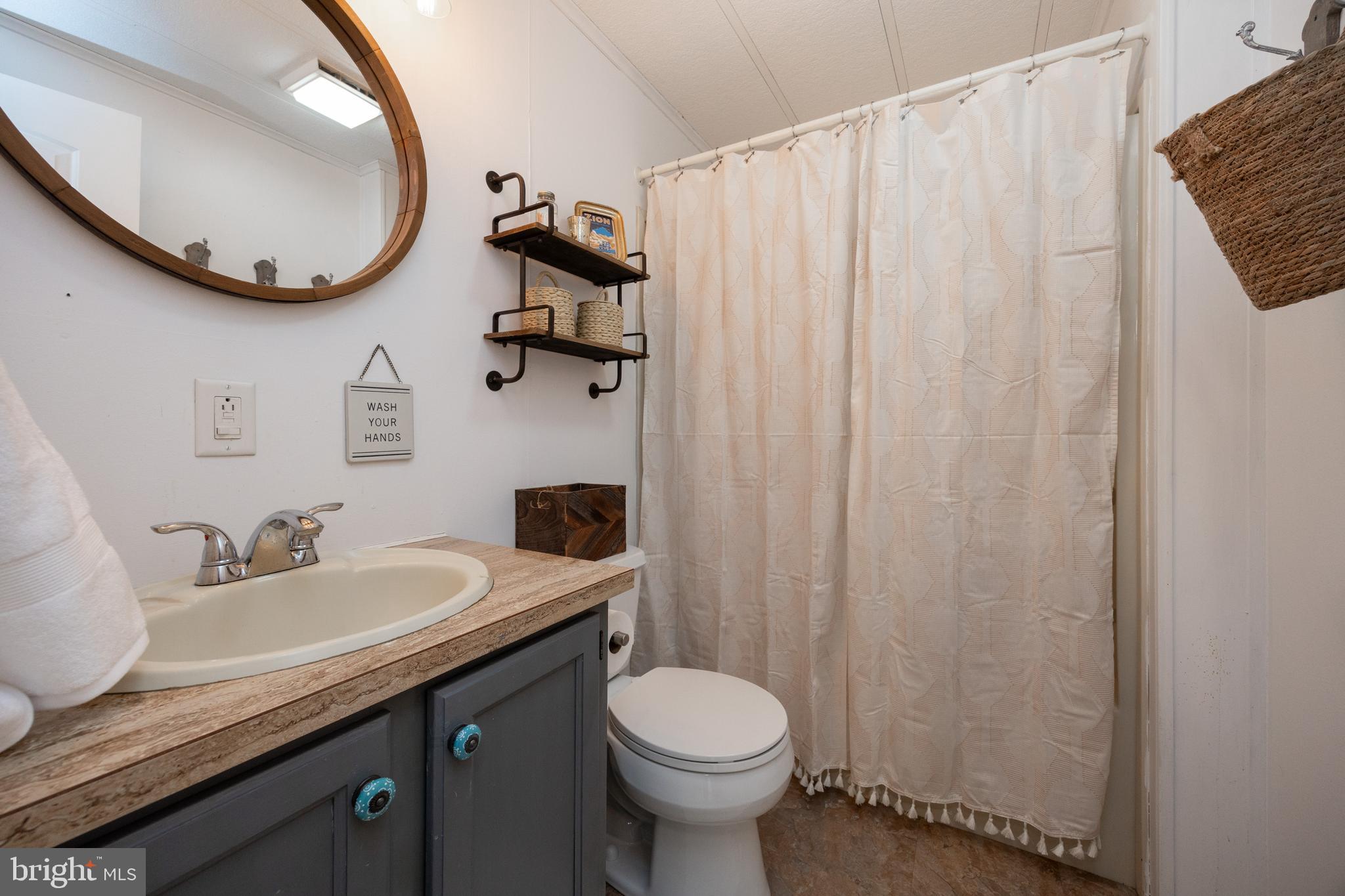 1524 Jonathan Road West Chester, PA 19380 - Photo 21 of 26 a bathroom with a granite countertop sink and a mirror