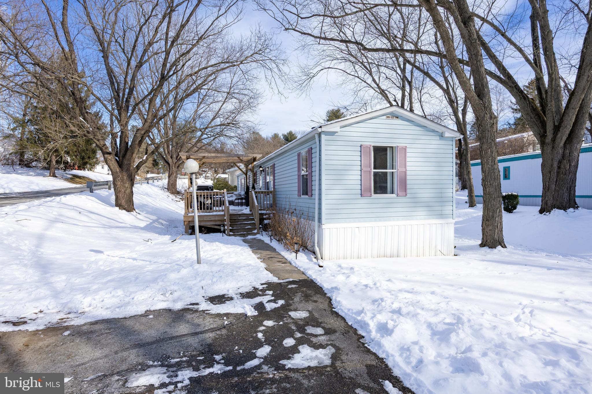 1524 Jonathan Road West Chester, PA 19380 - Photo 25 of 26 a front view of a house with a yard covered in snow