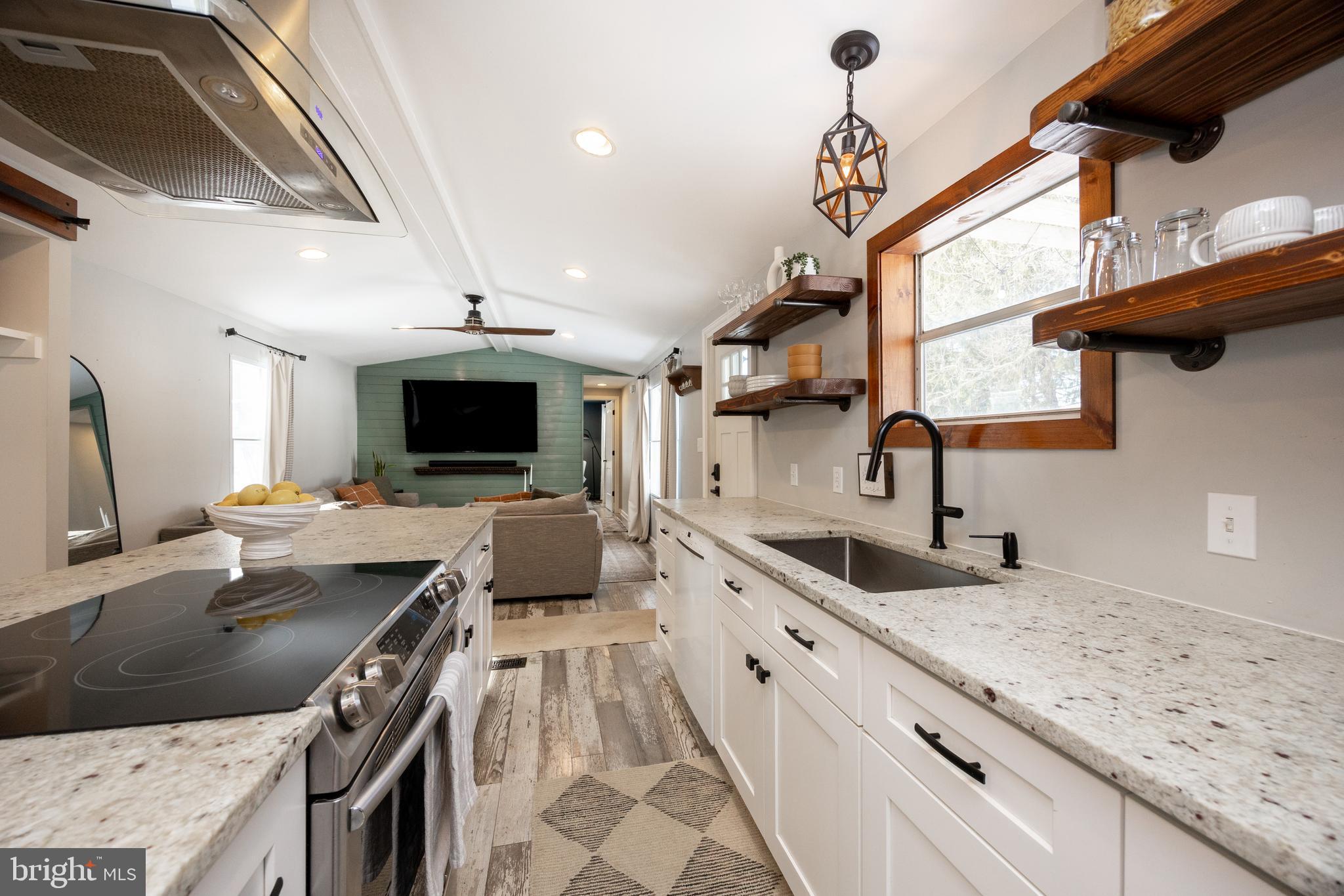 1524 Jonathan Road West Chester, PA 19380 - Photo 6 of 26 a kitchen with granite countertop a sink stainless steel appliances and a counter top space