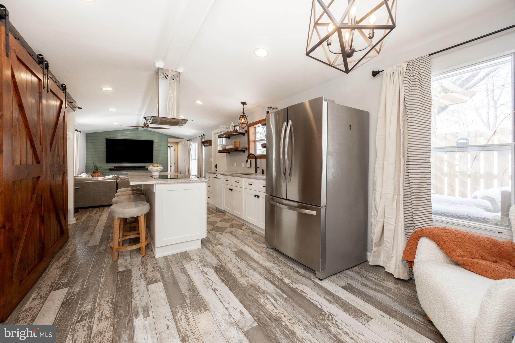1524 Jonathan Road West Chester, PA 19380 - Photo 8 of 26 a kitchen with stainless steel appliances a refrigerator a stove top oven a sink dishwasher and white cabinets with wooden floor