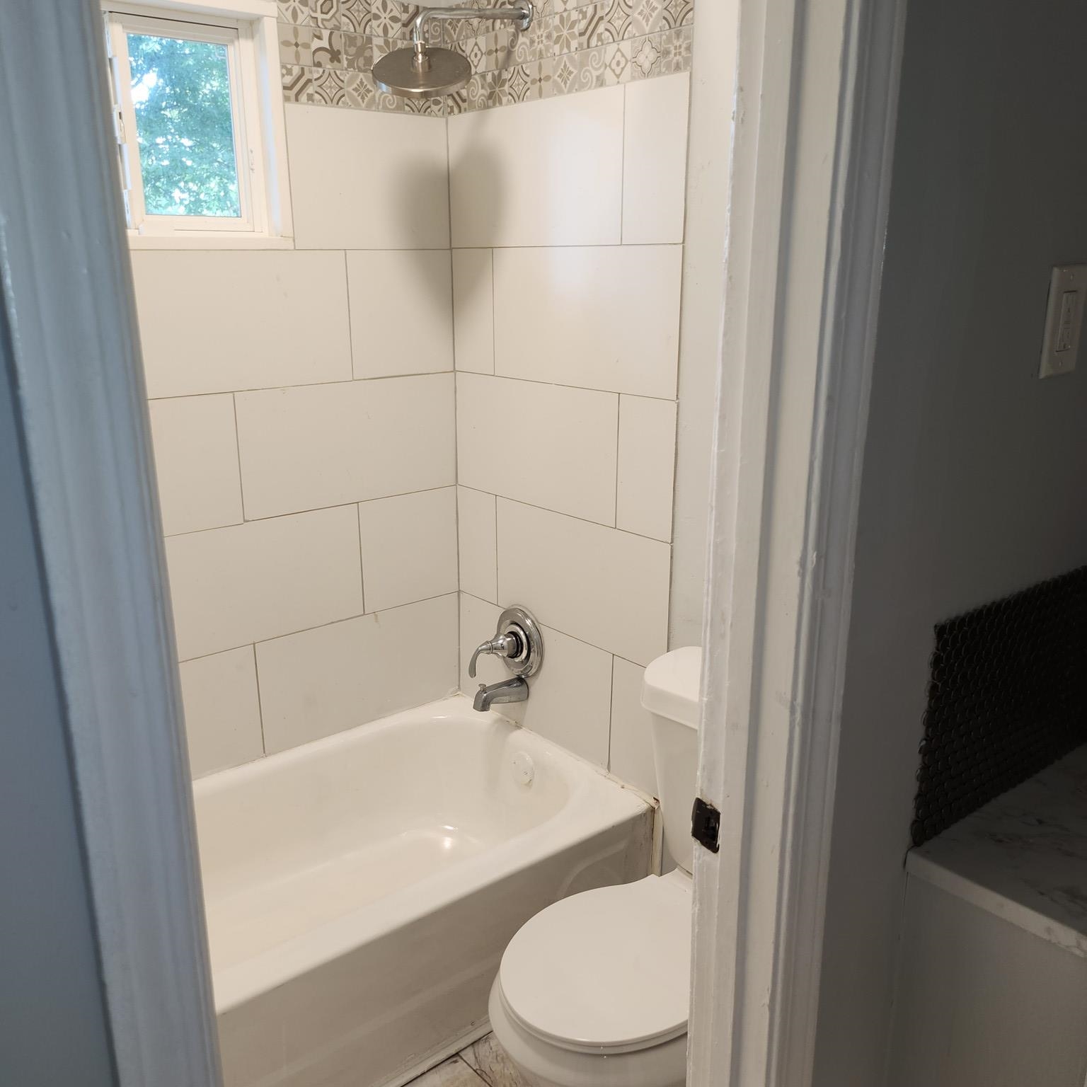 1220 Nora Road Memphis, TN 38109 - Photo 9 of 15 a white toilet sitting next to a bath tub
