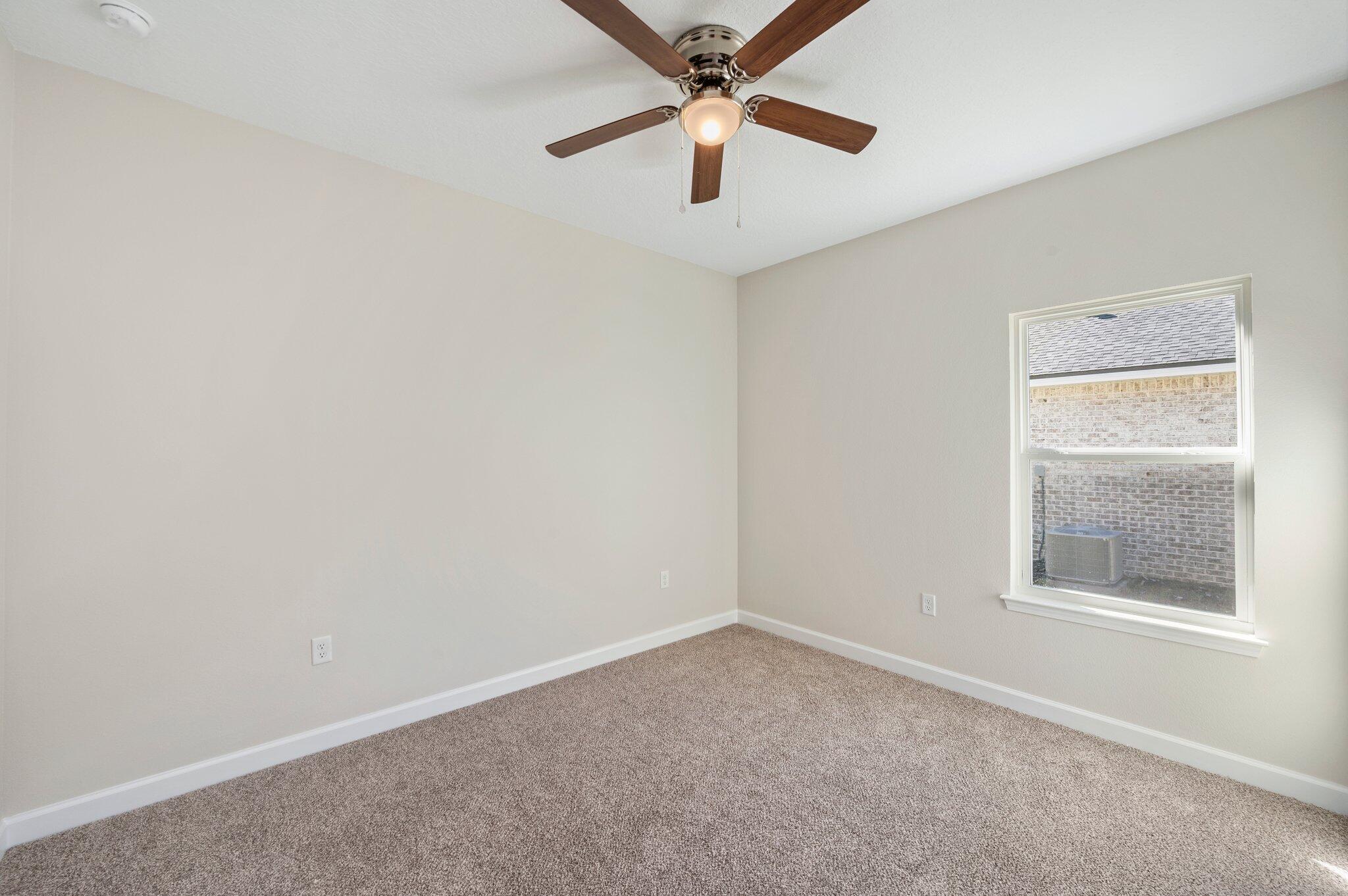 5459 Elzie Road Baker, FL 32531 - Photo 8 of 41 an empty room with a window and a fan