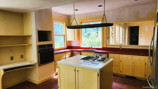 a kitchen that has a stove and a table in it