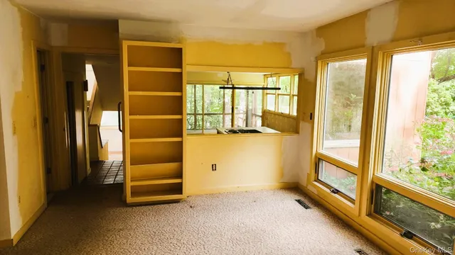 a view of walk in closet with empty room