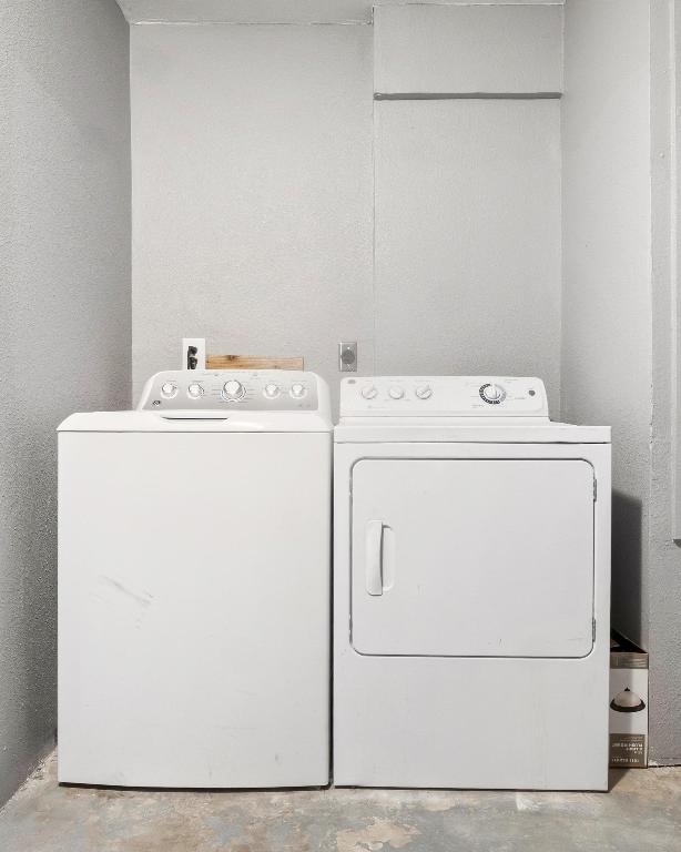 2405 Parker Circle, Unit B Georgetown, TX 78628 - Photo 16 of 23 Laundry area with a textured wall, unfinished concrete flooring, and washing machine and dryer